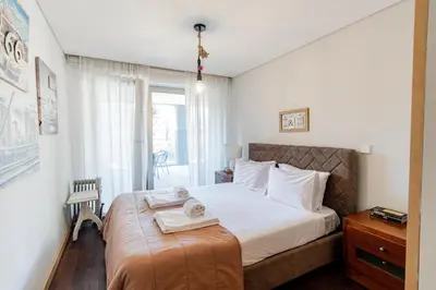 a bedroom with a bed with two towels on it at D João IV Apartment With Terrace by LovelyStay in Porto