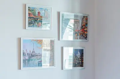 a group of framed pictures on a wall at D João IV Apartment With Terrace by LovelyStay in Porto
