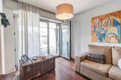 a living room with a couch and a table at D João IV Apartment With Terrace by LovelyStay in Porto