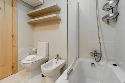 a bathroom with a toilet and a sink and a shower at D João IV Apartment With Terrace by LovelyStay in Porto