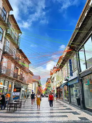 a group of people walking down a city street at Own Places Cedofeita Apartments in Porto