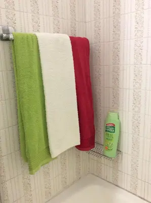 a group of towels hanging on a rack in a bathroom at Downtown Sunny Apartment in Porto