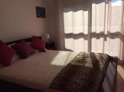 a bedroom with a large bed with red pillows at Downtown Sunny Apartment in Porto