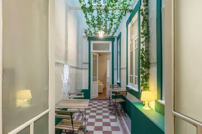 a hallway with tables and chairs in a building at APorTo - 2 Suites in Porto