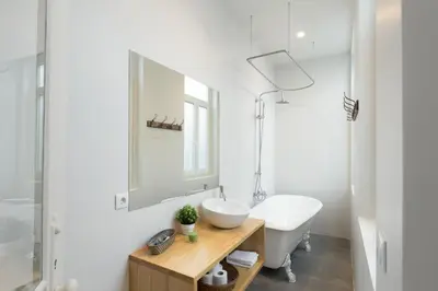 a white bathroom with a sink and a mirror at APorTo - 2 Suites in Porto