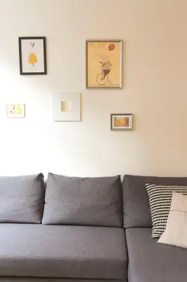 a gray couch in a living room with pictures on the wall at Taipas Plaza @ Historical Center in Porto