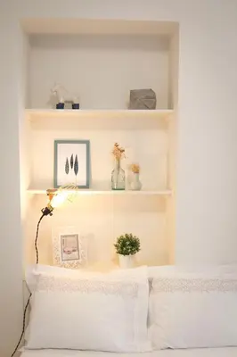 a bedroom with white walls and white shelves at Taipas Plaza @ Historical Center in Porto