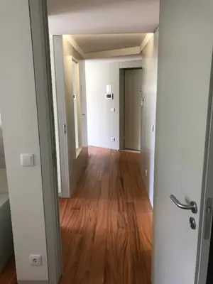 an empty hallway of an apartment with a hard wood floor at Lux Bolhão - ALL INCLUDED in Porto
