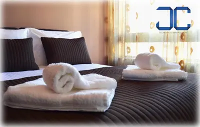 two towels on a bed with swans on it at Learn Porto Apartment by JC in Porto