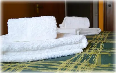 a stack of white towels sitting on a table at Learn Porto Apartment by JC in Porto