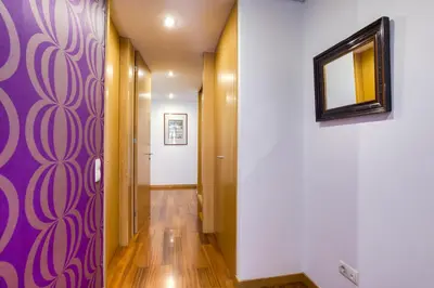 a hallway with purple and white walls and a mirror at Pretty Porto Apartment by SOULSHARING.PORTO in Porto