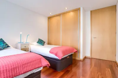 a bedroom with two beds and a closet at Pretty Porto Apartment by SOULSHARING.PORTO in Porto