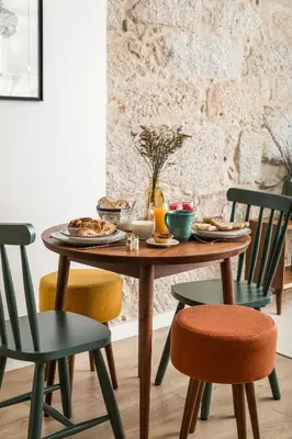 a table with plates of food and chairs at Bloom House by Sweet Porto in Porto