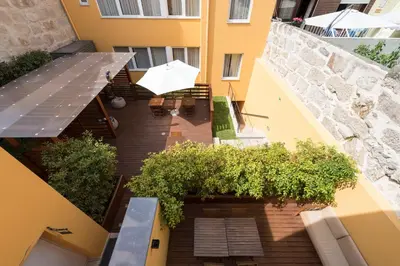 an overhead view of a balcony with a table and umbrella at Bloom House by Sweet Porto in Porto