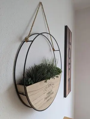 a hanging basket with plants in it on a wall at Pine Tree Apartment in Porto