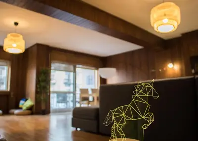 a paper dog on a table in a living room at Origami Porto Residência & Hostel in Vila Nova de Gaia