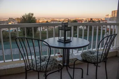 a table and two chairs on a balcony at Origami Porto Residência & Hostel in Vila Nova de Gaia