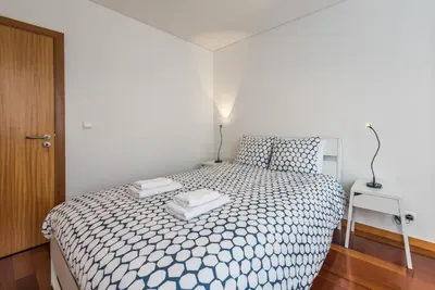 a bedroom with a bed with two towels on it at GuestReady - Ao Coliseu in Porto