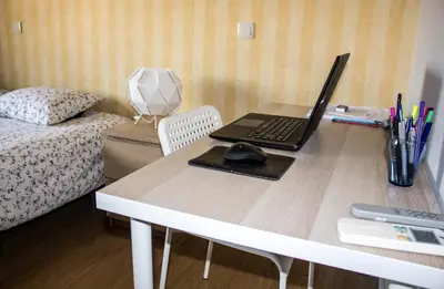 a desk with a laptop computer on top of it at Amazing Amial in Porto