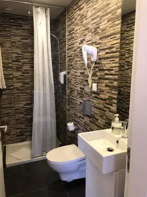 a bathroom with a sink and a toilet and a shower at Be Oporto Apartments Clérigos in Porto