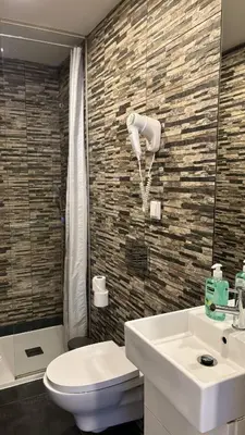 a bathroom with a sink and a toilet and a shower at Be Oporto Apartments Clérigos in Porto