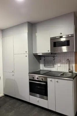 a kitchen with white cabinets and a stove top oven at Be Oporto Apartments Clérigos in Porto