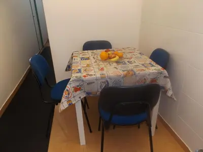 a table with blue chairs and a plate of oranges on it at Casa do Largo in Porto
