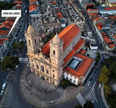 an old building with a clock tower in a city at Casa do Largo in Porto