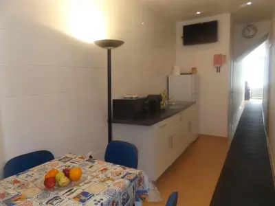 a kitchen with a table with fruit on it at Casa do Largo in Porto