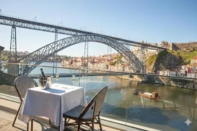 a table and chairs with a view of a bridge at Bridge It - Suites & Views in Vila Nova de Gaia