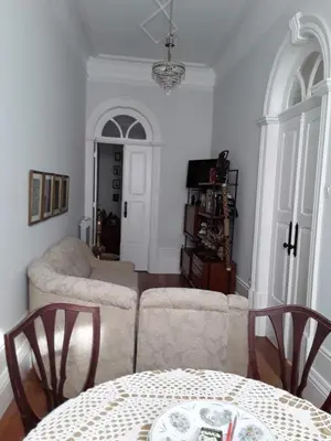 a living room with a couch and a table and chairs at Casa Familiar do Porto in Porto