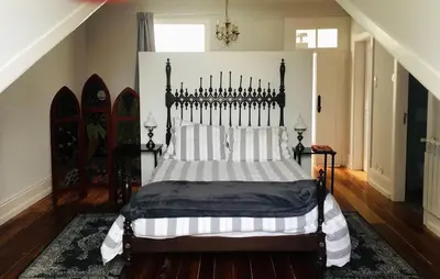 a bedroom with a bed with a black and white comforter at Casa Familiar do Porto in Porto