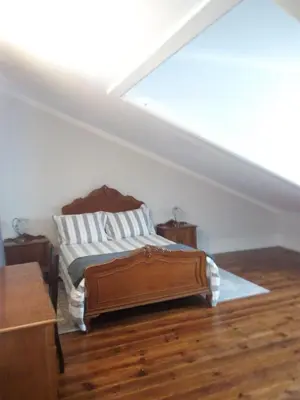 a bedroom with a bed in a attic at Casa Familiar do Porto in Porto