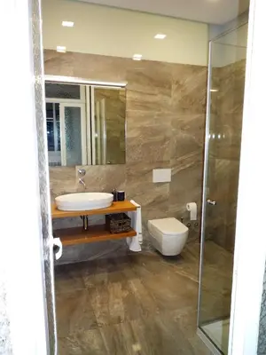 a bathroom with a sink and a shower and a toilet at Casa Familiar do Porto in Porto