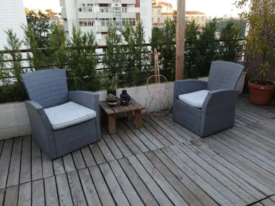two chairs and a table on a deck at Apartment Garden Music in Porto