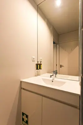 a bathroom with a sink and a mirror at RVA - Gustave Eiffel Apartments in Porto