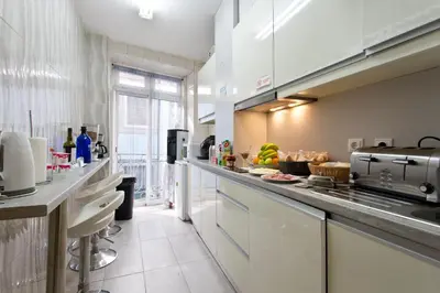 a large kitchen with a counter with food on it at Braganca Oporto in Porto