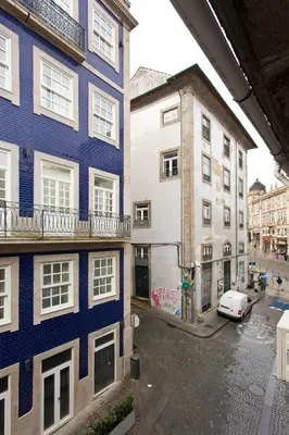 a view of a street with two buildings and a car at Braganca Oporto in Porto