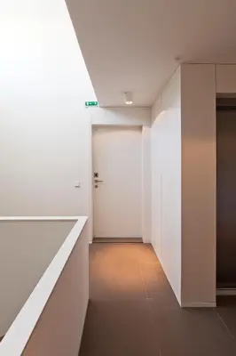 a hallway with white walls and a white door at bnapartments Palacio in Porto