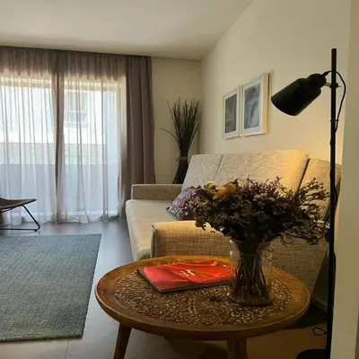 a living room with a vase of flowers on a table at bnapartments Palacio in Porto