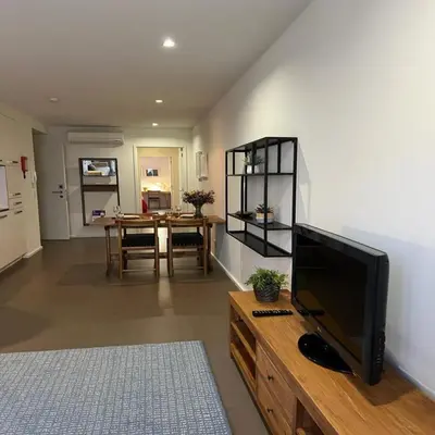 a living room with a flat screen tv on a wooden table at bnapartments Palacio in Porto