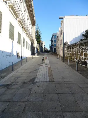 an empty sidewalk next to a building at bnapartments Palacio in Porto