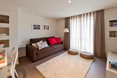 a living room with a couch and a window at bnapartments Palacio in Porto