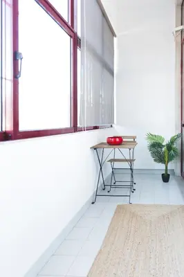 an empty room with a table and a window at APOSENTUS - Your Home in Martires da Liberdade in Porto