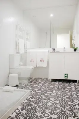 a white bathroom with a tub and a sink at HM - Carlos Alberto Apartment 2 in Porto