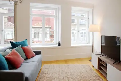 a living room with a couch and two windows at HM - Carlos Alberto Apartment 2 in Porto