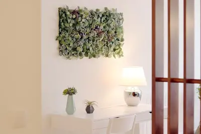 a room with a table with a flower painting on the wall at HM - Carlos Alberto Apartment 2 in Porto