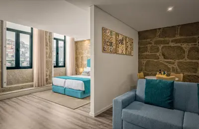 a bedroom with a bed and a couch and a chair at 296 Heritage Apartments in Vila Nova de Gaia
