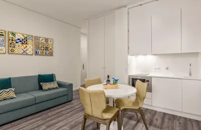 a living room with a couch and a table and chairs at 296 Heritage Apartments in Vila Nova de Gaia