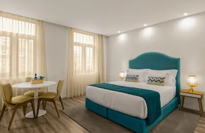 a bedroom with a bed and a table and chairs at 296 Heritage Apartments in Vila Nova de Gaia